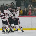 Juneau-Douglas High School: Yadaa.at Kalé senior Dylan Sowa, junior Elliot Welch, senior Xander Smith and senior Carter Miller celebrate a goal against Bartlett during the Crimson Bears 10-6 win over the Golden Bears on Saturday at Treadwell Ice Arena. (Klas Stolpe / Juneau Empire)