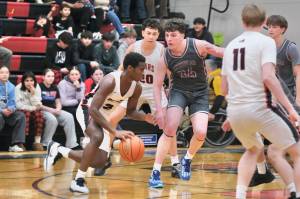Juneau-Douglas High School: Yadaa.at Kalé senior Ahmir Parker (2), junior Elias Dybdahl (20) and senior Ben Sikes (11) in action last week against Ketchikan. The three Crimson Bears played key roles in JDHS 64-49 win over Soldotna on Thursday in the Palmer Elks Showdown tournament at Palmer. The Crimson Bears continue play on Friday and Saturday. (Klas Stolpe / Juneau Empire file photo)