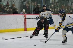 Juneau-Douglas High School: Yadaa.at Kalé senior Zander Smith (8) works for a puck against Bartlett in last Saturdays 10-6 Crimson Bears win over the Golden Bears at Juneaus Treadwell Ice Arena. Smith was voted a player of the match against Houston in Thursdays Crimson Bears win over the Hawks. (Klas Stolpe / Juneau Empire file photo)