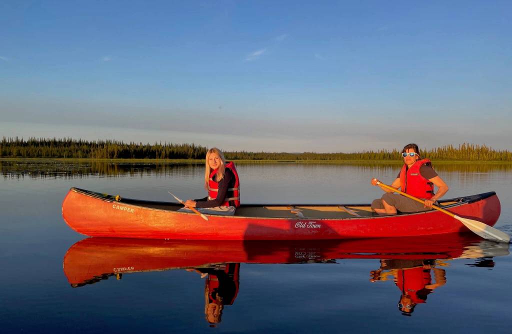 From left, Anna and Kristen Rozell canoe upon Deadman Lake in July 2023. Deadman Lake is part of the 934,513 acres of Tetlin National Wildlife Refuge, established in 1980 as part of the Alaska National Interest Lands Conservation Act. (Photo by Ned Rozell)