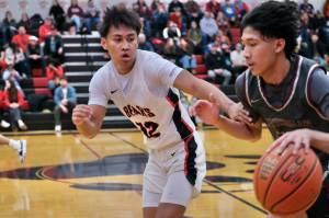 Juneau-Douglas High School: Yadaa.at Kalé junior Joren Gasga (12) guarding Ketchikans Edward Dela Cruz last weekend. Gasga was part of JDHS defensive pressure in Fridays 71-46 win over Homer at the Palmer Elks Tournament in Palmer. (Klas Stolpe / Juneau Empire file photo)