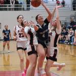 Juneau-Douglas High School: Yadaa.at Kalé sophomore Layla Tokuoka and freshman Lydia Goins (15) defend Soldotna senior Anika Jedlicka (4) as JDHS senior Cailynn Baxter (23) and junior Gwen Nizich (11) follow the play during the Crimson Bears 65-28 win over the Stars on Friday at the George Houston Gymnasium. (Klas Stolpe / Juneau Empire)