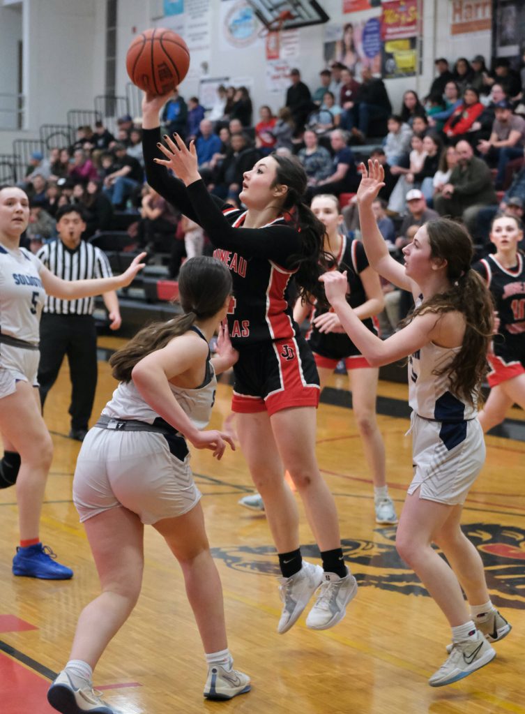 Juneau-Douglas High School: Yadaa.at Kalé sophomore Layla Tokuoka scores against Soldotna during the Crimson Bears 63-26 win over the Stars on Saturday at the George Houston Gymnasium. (Klas Stolpe / Juneau Empire)