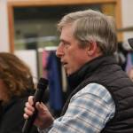 Aaron Brakel asks a question to the Juneau delegation during a town hall in the Dzantiki Heeni school commons on Monday, Jan. 13, 2025. (Jasz Garrett / Juneau Empire)