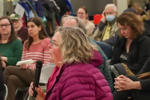Kristin Garot asks a question to members of Juneaus legislative delegation at a town hall in the Dzantiki Heeni school commons on Monday, Jan. 13, 2025. (Jasz Garrett / Juneau Empire)