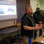 Details about a proposed set of totem poles at the Mendenhall Glacier Visitor Center are explained Wednesday by Jeremy Timothy, cultural ambassador program manager for Central Council of the Tlingit and Haida Indian Tribes of Alaska, during an open house Wednesday at the U.S. Forest Services Juneau Ranger District office. (Mark Sabbatini / Juneau Empire)