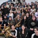 Members of the Juneau-Douglas High School: Yadaa.at Kalé Crimson Bears pep band pose for a photo at practice this week. The band  a fixture at sporting events and source of community spirit  is known throughout Southeast. (Klas Stolpe / Juneau Empire)