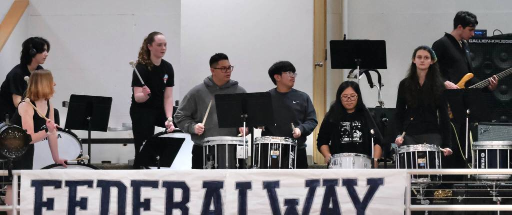 Members of the Juneau-Douglas High School: Yadaa.at Kalé Crimson Bears pep band perform during a home game at the George Houston Gymnasium earlier this season. (Klas Stolpe / Juneau Empire)
