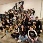 Members of the Juneau-Douglas High School: Yadaa.at Kalé Crimson Bears pep band pose for a photo at practice this week. The band  a fixture at sporting events and source of community spirit  is known throughout Southeast. (Klas Stolpe / Juneau Empire)