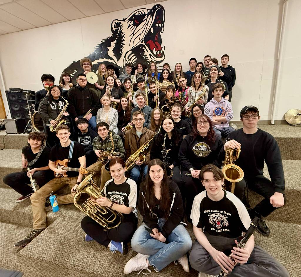 Members of the Juneau-Douglas High School: Yadaa.at Kalé Crimson Bears pep band pose for a photo at practice this week. The band  a fixture at sporting events and source of community spirit  is known throughout Southeast. (Klas Stolpe / Juneau Empire)