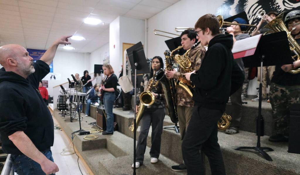 Members of the Juneau-Douglas High School: Yadaa.at Kalé Crimson Bears pep band perform during a home game at the George Houston Gymnasium earlier this season. (Klas Stolpe / Juneau Empire)