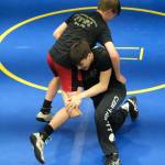Thunder Mountain Middle School seventh grader Andrew Erickson and eighth grader Landon Hill practice a technique during a three-day wrestling clinic at the Juneau Wrestling Center on Monday. The clinic was taught by Askren Wrestling Academy coach Wilder Wichman. (Klas Stolpe / Juneau Empire)