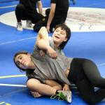 Thunder Mountain Middle School student Minali Reid works a technique with Cash Miller on Monday during a three-day wrestling clinic at the Juneau Wrestling Center led by Askren Wrestling Academy coach Wilder Wichman. (Klas Stolpe / Juneau Empire)