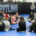 Askren Wrestling Academy coach Wilder Wichman demonstrates a technique on Monday during a three-day wrestling clinic at the Juneau Wrestling Center. (Klas Stolpe / Juneau Empire)