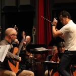 John Unzicker, Juneau Symphonys featured soloist, plays guitar while music director candidate Wilbur Lin conducts on Jan. 23, 2025. (Jasz Garrett / Juneau Empire)