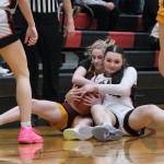 Dimond junior Katie MacDonald and Juneau-Douglas High School: Yadaa.at Kalé sophomore Layla Tokuoka battle for a ball during Fridays Crimson Bears 62-48 win over the Lynx inside the George Houston Gymnasium. The teams play Saturday at 7 p.m. (Klas Stolpe / Juneau Empire)