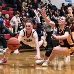 Juneau-Douglas High School: Yadaa.at Kalé junior Gwen Nizich (11) and Dimond senior Sienna Pederson (23) dive for a ball during Fridays Crimson Bears 62-48 win over the Lynx inside the George Houston Gymnasium. The teams play Saturday at 7 p.m. (Klas Stolpe / Juneau Empire)