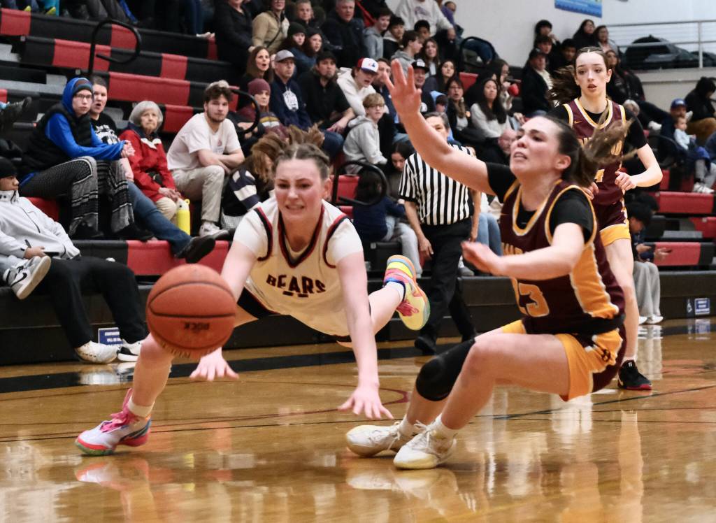 Juneau-Douglas High School: Yadaa.at Kalé junior Gwen Nizich (11) and Dimond senior Sienna Pederson (23) dive for a ball during Fridays Crimson Bears 62-48 win over the Lynx inside the George Houston Gymnasium. The teams play Saturday at 7 p.m. (Klas Stolpe / Juneau Empire)