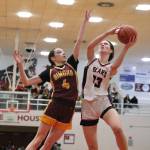 Dimond junior Sophie Scott (4) defends a shot by Juneau-Douglas High School: Yadaa.at Kalé senior Cailynn Baxter (23) during Fridays JDHS Crimson Bears 62-48 win over the visiting Lynx inside the George Houston Gymnasium. The teams play Saturday at 7 p.m. (Klas Stolpe / Juneau Empire)