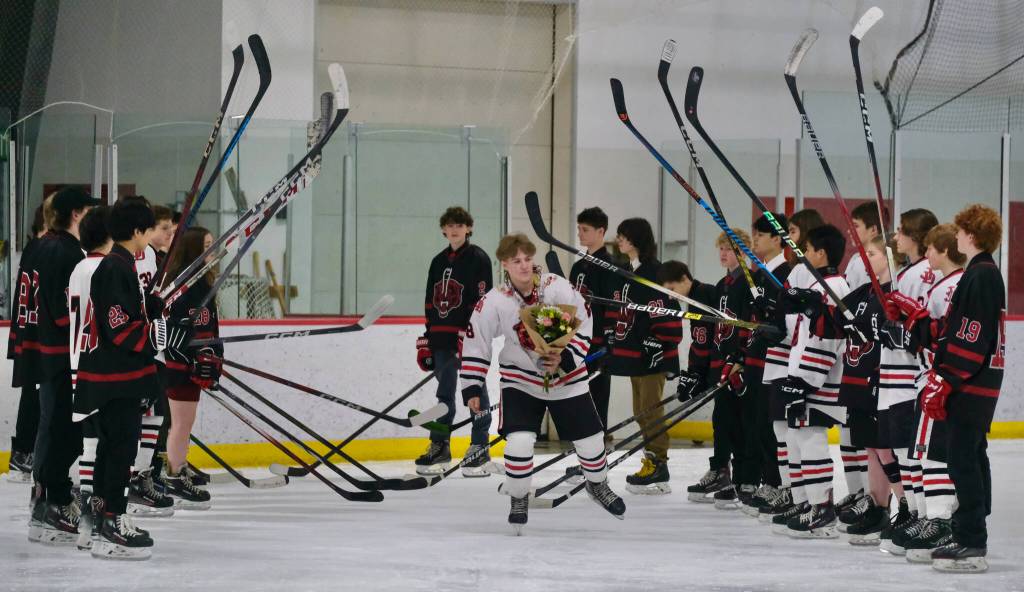 Juneau-Douglas High School: Yadaa.at Kalé senior Zander Smith skates onto the ice during ceremonies before the Crimson Bears game Friday against the visiting Kenai Kardinals at Treadwell Ice Arena. (Klas Stolpe / Juneau Empire)