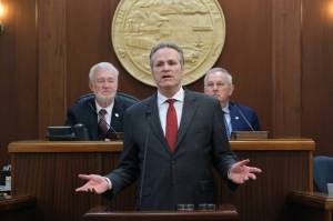 Gov. Mike Dunleavy delivers his State of the State speech at the Alaska State Capitol on Tuesday, Jan. 28, 2025, with Senate President Gary Stevens, at left, and House Speaker Bryce Edgmon, at right, in the background. (Klas Stolpe/Juneau Empire)