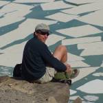 Ned Rozell sits at the edge of the volcanic crater on Mount Katmai during a trip to the Valley of 10,000 Smokes in 2001. (Photo by John Eichelberger)
