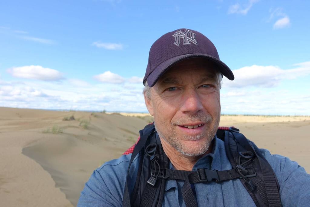 Ned Rozell hikes a sandy ridge at western Alaskas Nogahabara Dunes in summer 2024. (Photo by Ned Rozell)