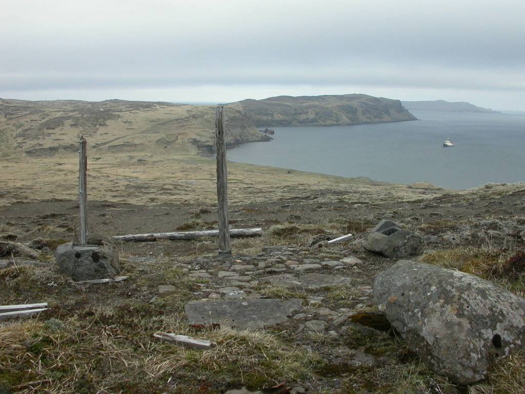 A Shinto shrine remains on Kiska Island after a brief Japanese occupation during World War II. The Alaska Maritime National Wildlife Refuges ship, the Tiglax, floats in the background. (Photo by Ned Rozell)