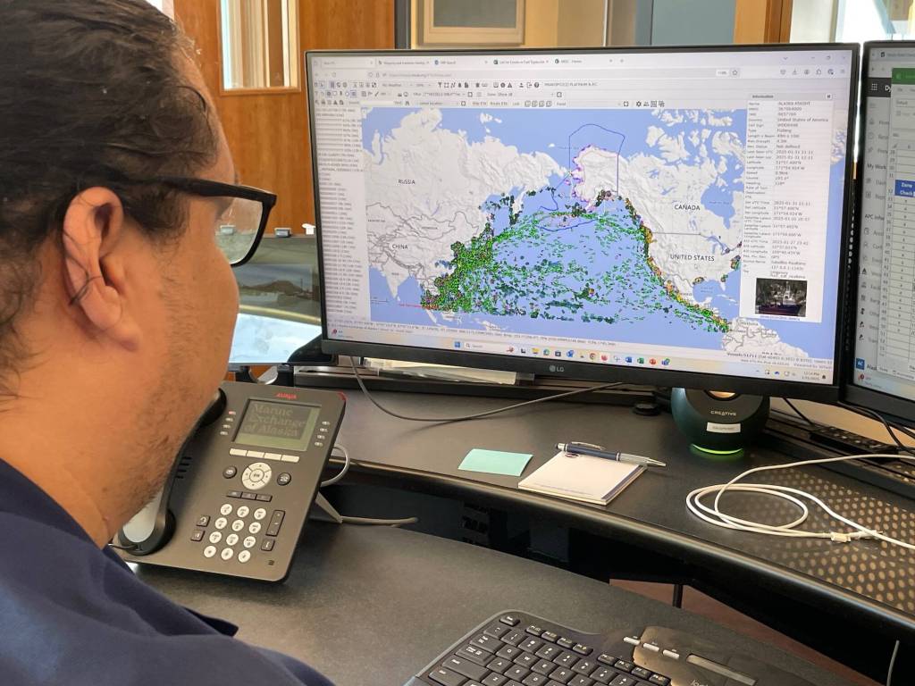 Edward Rivera scans a computer screen tracking 51,000 ships in the Pacific Ocean on Friday morning. (Laurie Craig / Juneau Empire)