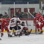 Juneau-Douglas High School: Yadaa.at Kalé senior goalie Caleb Friend keeps the puck out of the net during the Crimson Bears 3-1 win over the Warriors at Treadwell Ice Arena on Saturday. (Klas Stolpe / Juneau Empire)