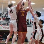 Mt. Edgecumbe senior Donovan Stephen-Standifer (35) is defended by Juneau-Douglas High School: Yadaa.at Kalé senior Ben Sikes (11) and juniors Brandon Casperson and Joren Gasga during the Braves 68-47 win over the Crimson Bears on Saturday in the George Houston Gymnasium. (Klas Stolpe / Juneau Empire)