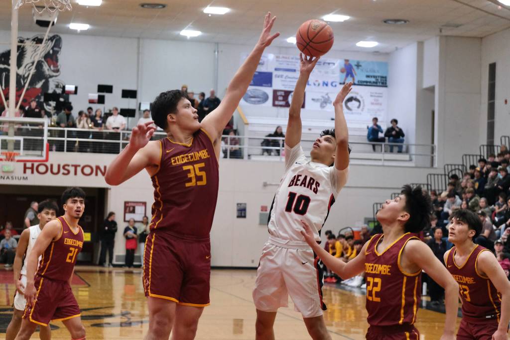 Juneau-Douglas High School: Yadaa.at Kalé senior Pedrin Saceda-Hurt (10) attempts a shot over Mt. Edgecumbe senior Donovan Stephen-Standifer (35) during the Crimson Bears 68-47 loss to the Braves on Saturday in the George Houston Gymnasium. (Klas Stolpe / Juneau Empire)