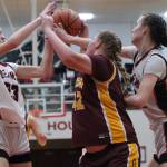 In this file photo Juneau-Douglas High School: Yadaa.at Kalé seniors Cailynn, left, and Kerra Baxter, right, battle for a rebound against Dimond High School. The Baxters led JDHS in scoring this weekend at Mt. Edgecumbe with Cailynn hitting 23 on Friday and Kerra 28 on Saturday. (Klas Stolpe / Juneau Empire file photo)