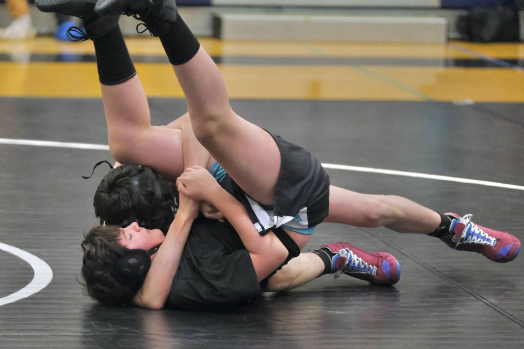 Thunder Mountain Middle School eighth grader Luke Darbonne of team Orange Crush uses a Crossface Cradle to pin Black Bear Legions Aero Ekerson during the inaugural Thunder Mountain Mayhem Team Duels wrestling tournament Saturday at TMMS. (Klas Stolpe / Juneau Empire)