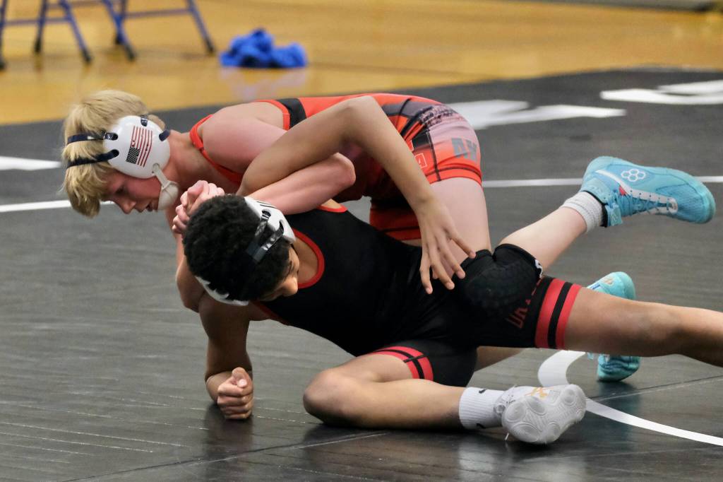 Black Bear Legions Rawley Cox tries a move on Orange Crushs Momar Diouf during the inaugural Thunder Mountain Mayhem Team Duels wrestling tournament Saturday at Thunder Mountain Middle School. (Klas Stolpe / Juneau Empire)