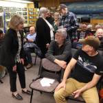 Juneau Assembly Member Maureen Hall (left) and Mayor Beth Weldon (center) talk to residents during a break in an Assembly meeting Monday, Feb. 3, 2025, about the establishment of a Local Improvement District that would require homeowners in the area to pay nearly $6,300 each for barriers to protect against glacial outburst floods. (Mark Sabbatini / Juneau Empire)