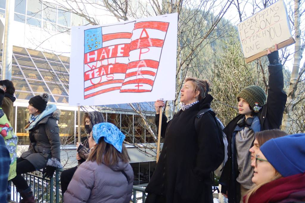 Stephanie Strickland, and her son, Benjamin, 11, hold a sign he made during a protest in front of the Alaska State Capitol on Wednesday focused on President Donald Trumps actions since the beginning of his second term. (Mark Sabbatini / Juneau Empire)