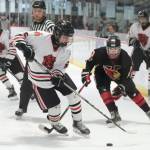 In this file photo Juneau-Douglas High School: Yadaa.at Kalé senior Ike Puustinen (16) controls a puck during senior night weekend against Kenai. On Friday the Crimson Bears lost 5-2 to Palmer at the 2025 ASAA Division II Hockey State Tournament in Soldotna and will face Kenai in the 3rd/5th-place game Saturday. (Klas Stolpe / Juneau Empire)