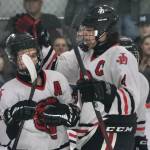 In this file photo Juneau-Douglas High School: Yadaa.at Kalé senior Dylan Sowa (35) is congratulated on a scoring goal by senior captain Luke Bovitz (4) during senior night weekend against Kenai. Sowa had two goals Friday in the Crimson Bears 5-2 loss to Palmer at the 2025 ASAA Division II Hockey State Tournament in Soldotna. JDHS will face Kenai in the 3rd/5th-place game Saturday. (Klas Stolpe / Juneau Empire)