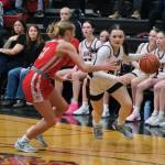 Juneau-Douglas High School: Yadaa.at Kalé sophomore Layla Tokuoka drives against Wasilla senior Mylee Anderson during the Crimson Bears 65-34 loss Friday to the Warriors in the George Houston Gymnasium. (Klas Stolpe / Juneau Empire)