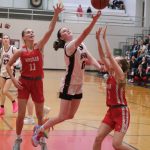 Juneau-Douglas High School: Yadaa.at Kalé junior Gwen Nizich (11) scoops a shot against Wasilla juniors Savannah Kroon (11) and Kinley Lynch (3) during the Crimson Bears 65-34 loss Friday to the Warriors in the George Houston Gymnasium. (Klas Stolpe / Juneau Empire)