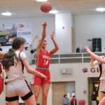 Wasilla senior Mylee Anderson (14) scores over Juneau-Douglas High School: Yadaa.at Kalé defenders during the Warriors 65-34 win over the Crimson Bears on Friday in the George Houston Gymnasium. (Klas Stolpe / Juneau Empire)