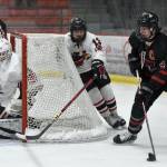 Lucas Bovitz of Juneau-Douglas: Yadaa.at Kale carries the puck with attention from Kenai Central goalie Evyn Witt and William Howard at the First National Cup Division II state hockey tournament Saturday at the Soldotna Regional Sports Complex in Soldotna. (Jeff Helminiak/Peninsula Clarion)