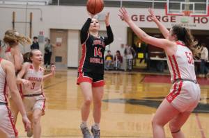 Juneau-Douglas High School: Yadaa.at Kalé sophomore Layla Tokuoka (14) floats a jump shot over Wasilla senior Layla Hays (52) during the Crimson Bears 46-30 loss Saturday to the Warriors in the George Houston Gymnasium. (Klas Stolpe / Juneau Empire)