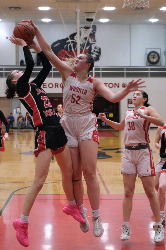 Juneau-Douglas High School: Yadaa.at Kalé senior Kerra Baxter (22) has a shot blocked by Wasilla senior Layla Hays (52) during the Crimson Bears 46-30 loss Saturday to the Warriors in the George Houston Gymnasium. (Klas Stolpe / Juneau Empire)
