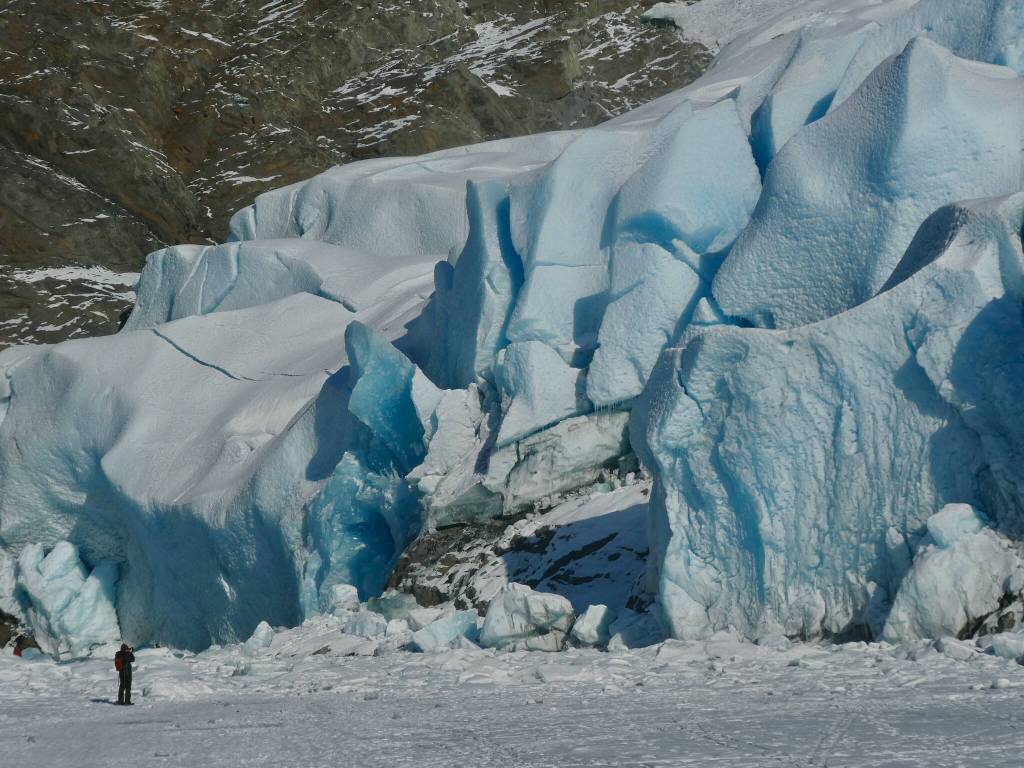 A person takes a photo at the face of the Mendenhall Glacier on Sunday, Feb. 9, 2025. (Klas Stolpe / Juneau Empire)