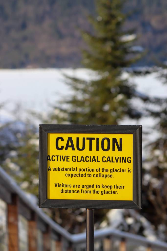 A warning sign posted at the Mendenhall Glacier Recreation Area on Thursday warns of active glacial calving and recommends keeping people away from the glaciers face. (Jasz Garrett / Juneau Empire)