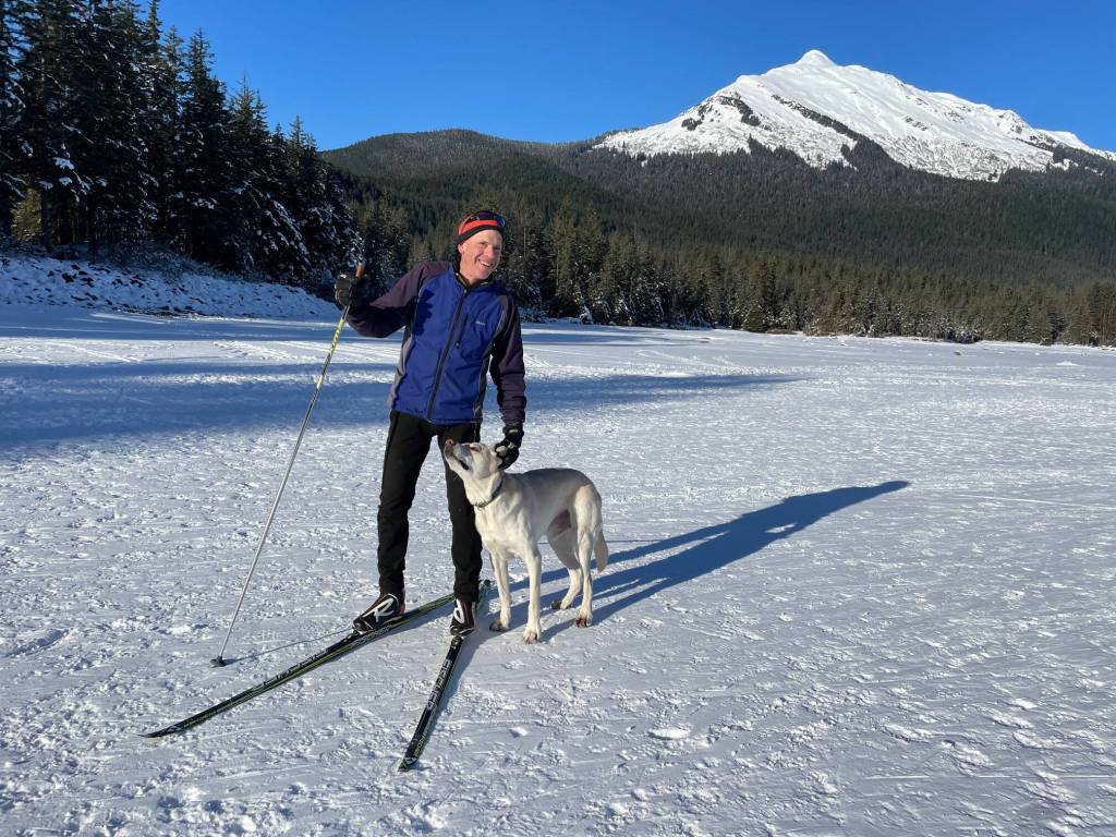 Skate skier Scott Watts and his dog complete a 37-minute run on a groomed trail that leads around a loop course on Mendenhall Lake on Tuesday, Feb. 11, 2025. (Laurie Craig / Juneau Empire)