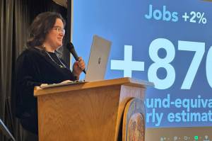 Meilani Schijvens, owner of Rain Coast Data, discusses regional economic data complied by her company during Southeast Conferences Mid-Season Summit at Elizabeth Peratrovich Hall on Tuesday. (Mark Sabbatini / Juneau Empire)