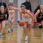 Juneau-Douglas High School: Yadaa.at Kalé sophomore Layla Tokuoka (14), Wasilla junior Kinley Lynch (12), Wasilla senior Mylee Anderson (14) and JDHS senior Mary Johnson (4) race for a ball during a Crimson Bears loss to the Warriors last weekend in the George Houston Gymnasium. JDHS will host Ketchikan at 7 p.m. Thursday and Friday. (Klas Stolpe / Juneau Empire)